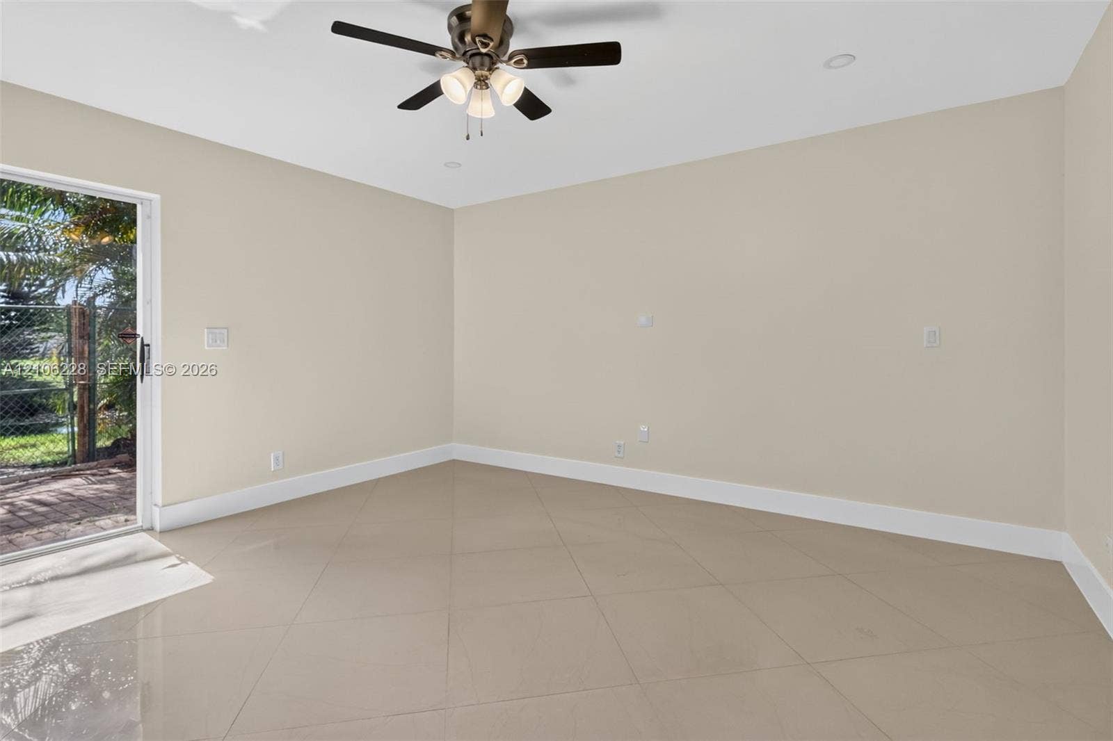 10760 SW 11th Drive, Davie, FL 33324 Neutral-toned interior featuring large-format tile flooring, a ceiling fan with integrated light fixture, recessed lighting, and a sliding glass door