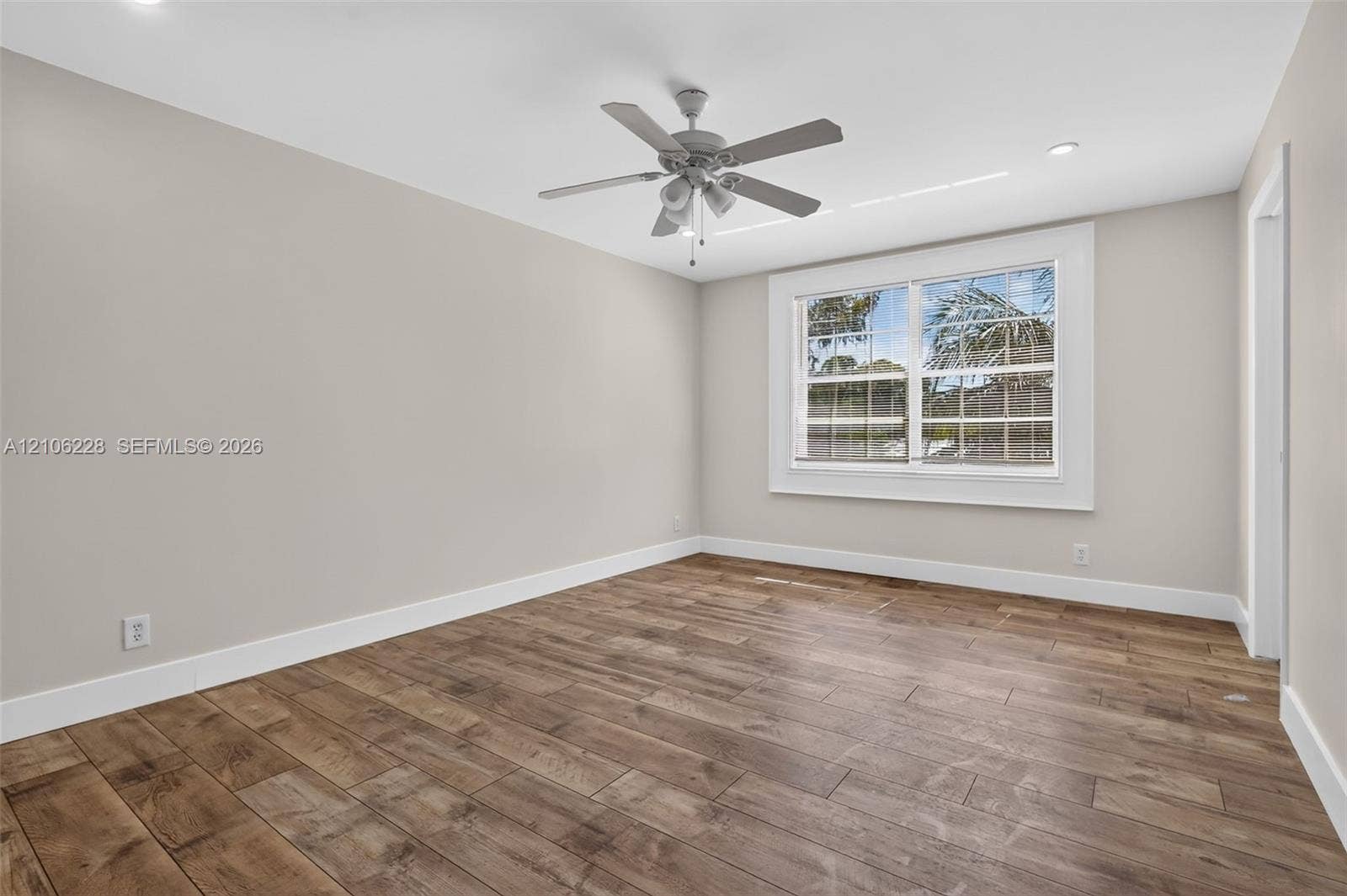 10760 SW 11th Drive, Davie, FL 33324 Neutral-toned interior featuring wood-finish flooring, recessed lighting, and a ceiling fan with integrated lighting fixtures