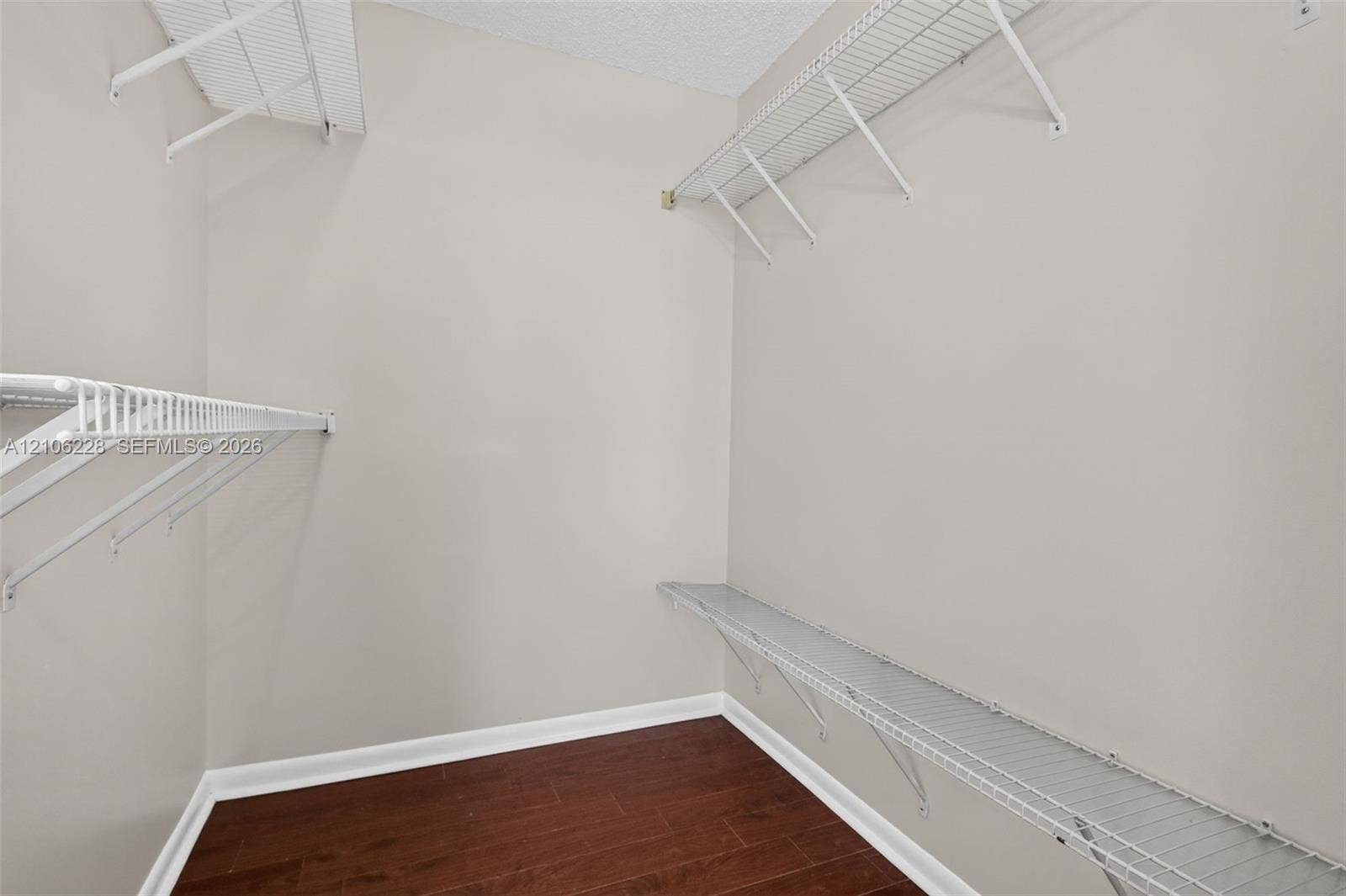 10760 SW 11th Drive, Davie, FL 33324 Walk-in closet featuring wood-finish flooring and multi-level white wire shelving