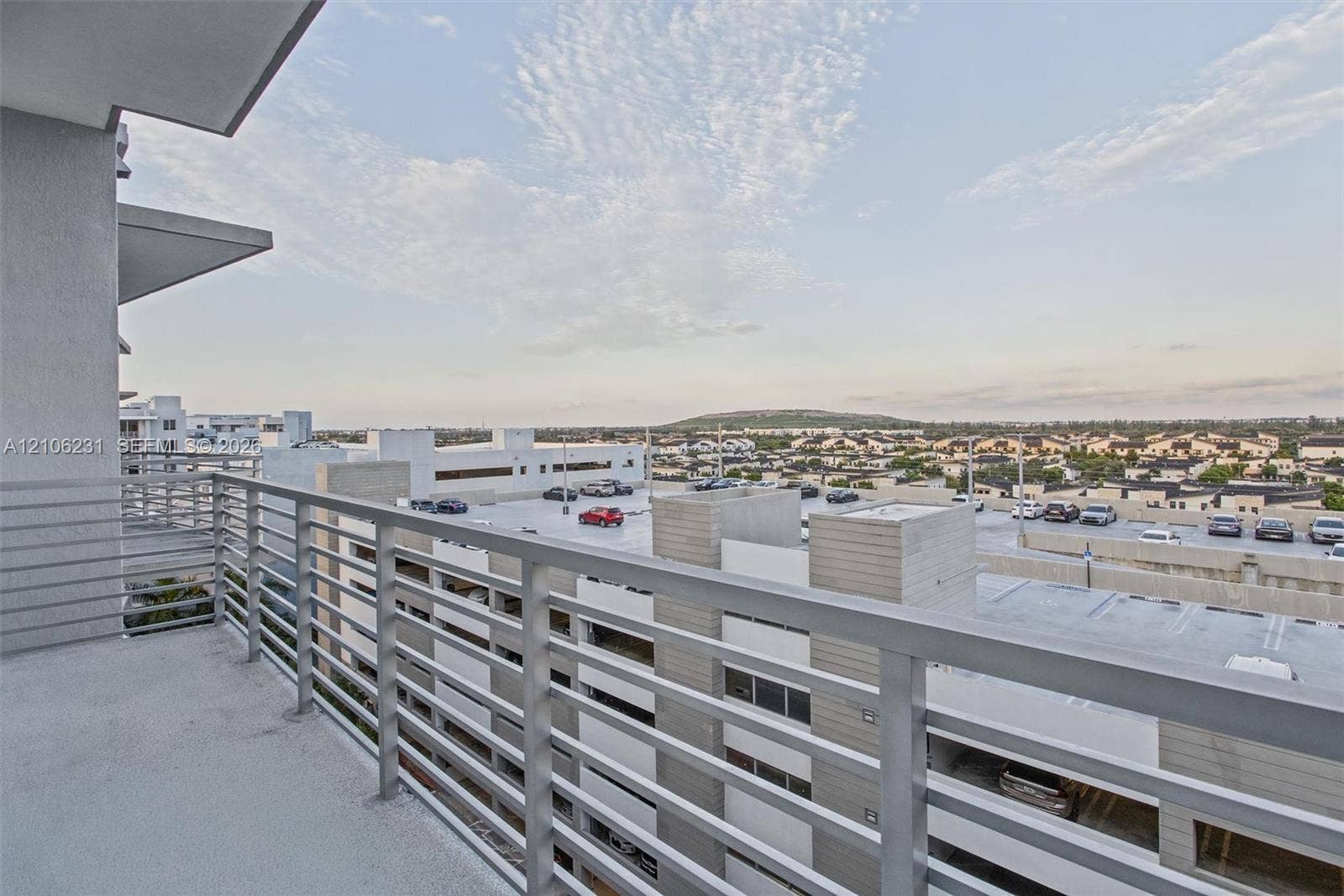 7875 NW 107th Avenue, #802, Doral, FL 33178 Private balcony featuring concrete flooring and a horizontal metal railing