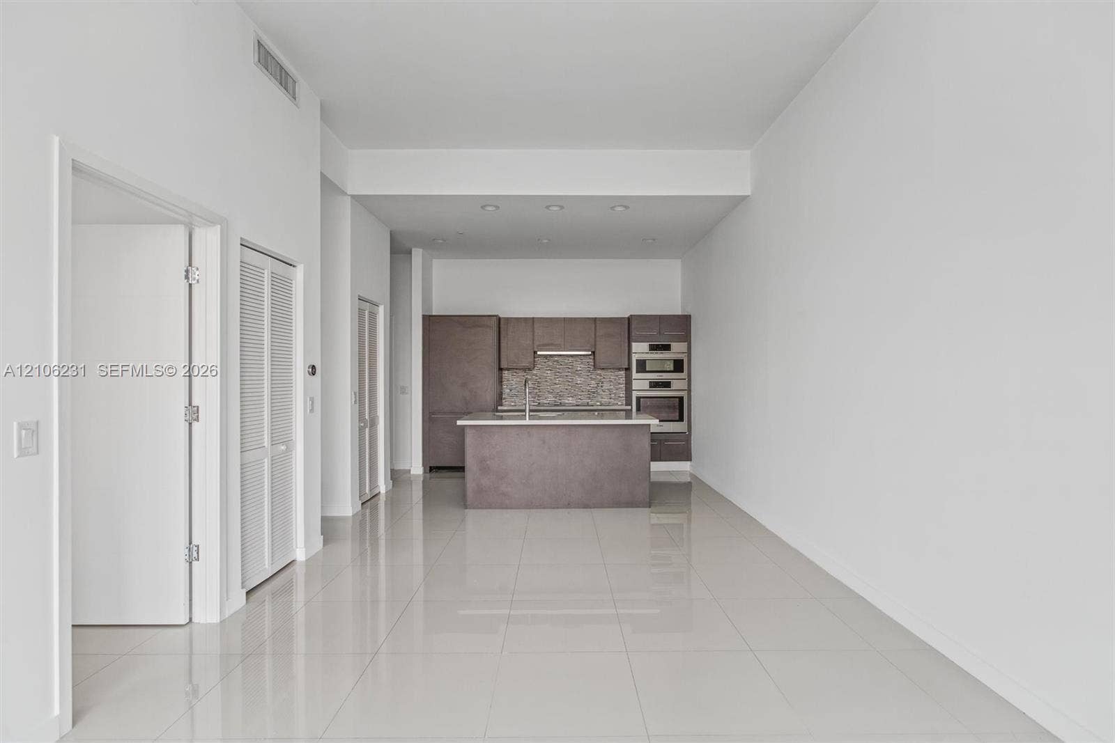 7875 NW 107th Avenue, #802, Doral, FL 33178 Living & Kitchen area seen from balcony door