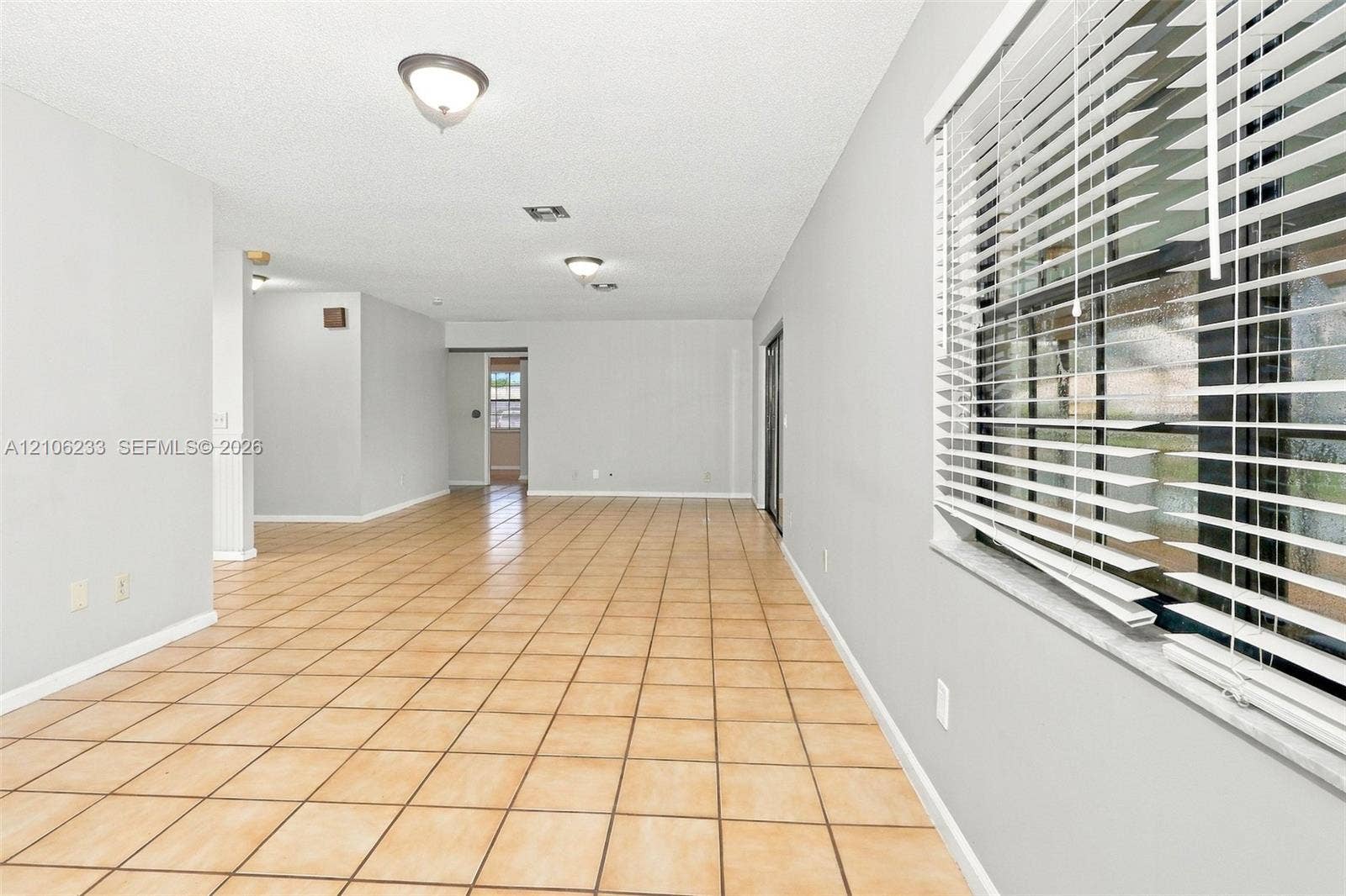 132 Santander Court, Royal Palm Beach, Royal Palm Beach, FL 33411 Open interior featuring ceramic tile flooring, neutral wall paint, recessed ceiling lighting, and horizontal window blinds