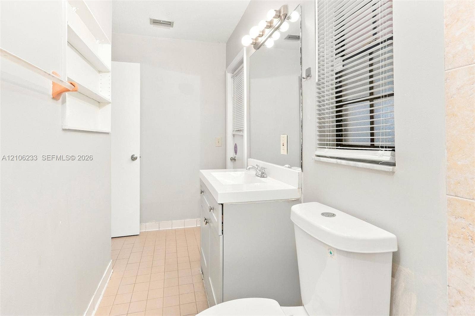 132 Santander Court, Royal Palm Beach, Royal Palm Beach, FL 33411 Bathroom vanity featuring a white rectangular sink, grey cabinetry, a full-width wall-mounted mirror, and tile flooring