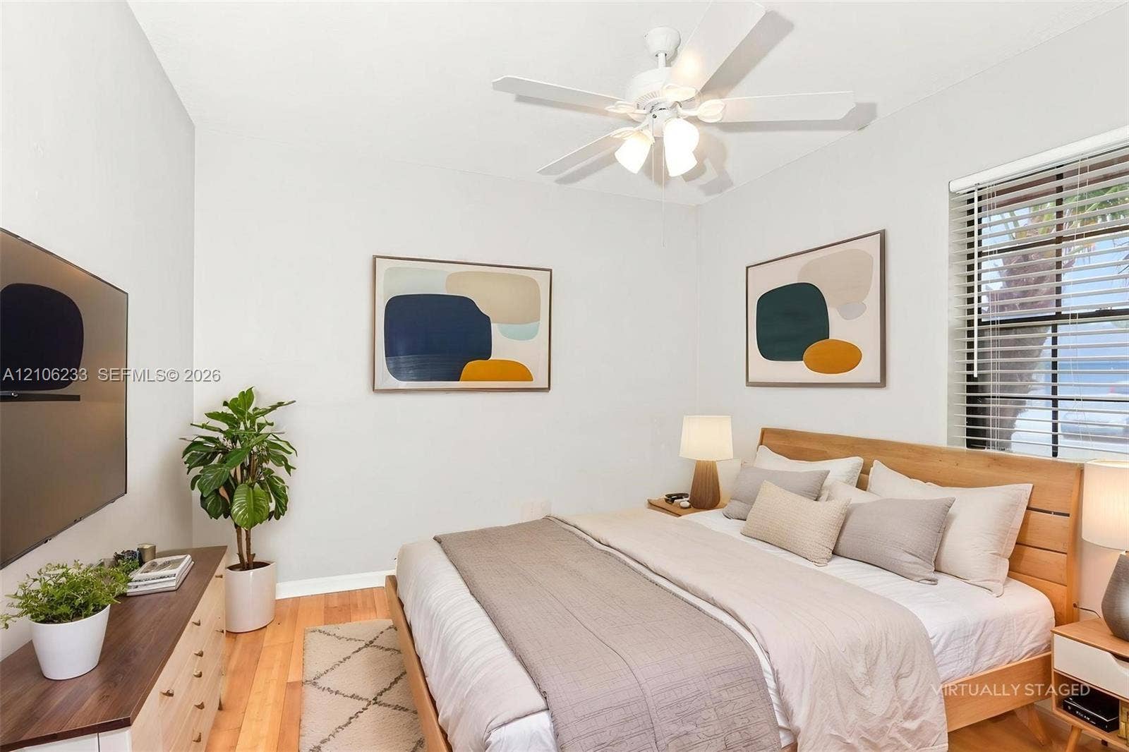132 Santander Court, Royal Palm Beach, Royal Palm Beach, FL 33411 Room featuring wood-finish flooring, a white ceiling fan with integrated light fixture, and blinds installed on the window