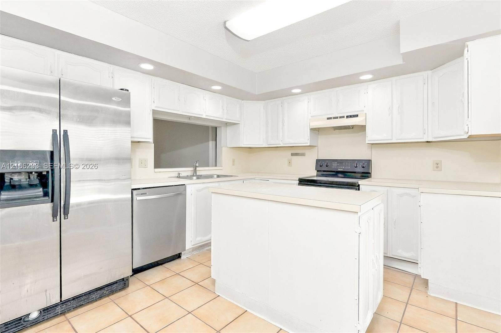 132 Santander Court, Royal Palm Beach, Royal Palm Beach, FL 33411 Kitchen featuring white cabinetry, a center island, stainless steel refrigerator and dishwasher, and tile flooring