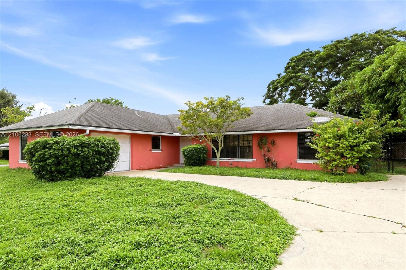 132 Santander Court, Royal Palm Beach, Royal Palm Beach, FL 33411 Single-story exterior featuring a hip roof, a concrete driveway, and an attached garage