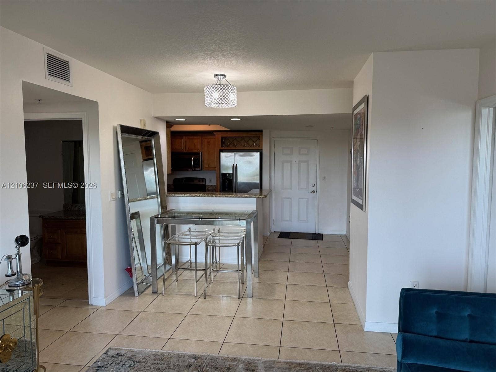 3530 SW 22nd Street, #706, Miami, Miami, FL 33145 Kitchen featuring a breakfast bar, wood cabinetry, built-in microwave, and tile flooring