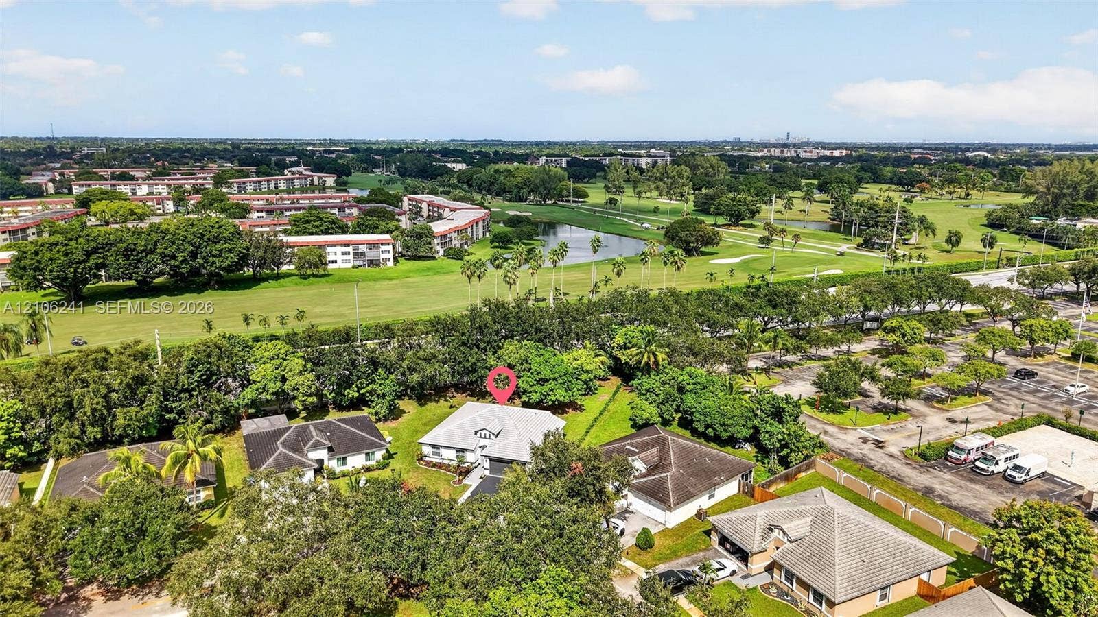 9407 SW 18th Street, Miramar, FL 33025 Aerial perspective of a detached residential property featuring a gable roof, exterior masonry facade, mature perimeter landscaping, and a paved private driveway
