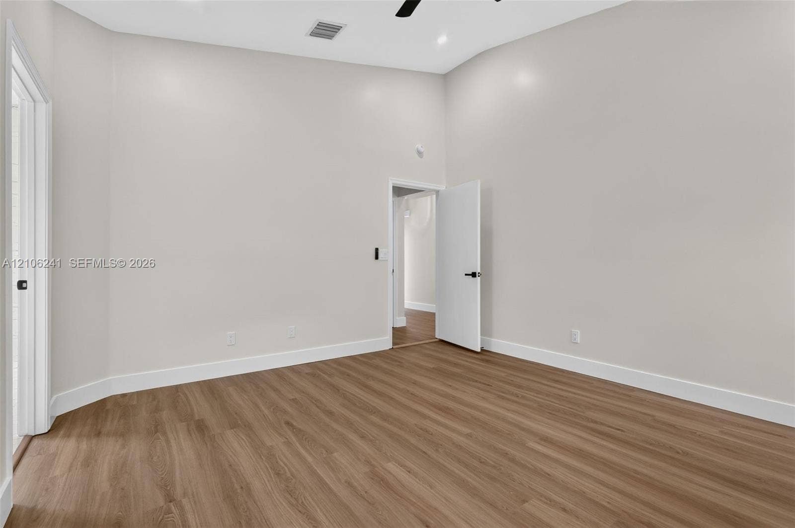 9407 SW 18th Street, Miramar, FL 33025 Interior space featuring high ceilings, wood-finish flooring, recessed lighting, and matte black door hardware