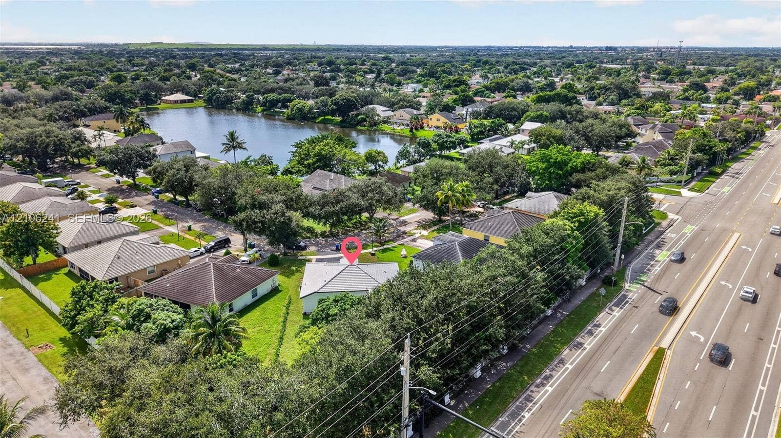9407 SW 18th Street, Miramar, FL 33025 Aerial perspective of a single-story residence featuring a hipped roof and a dedicated lawn area