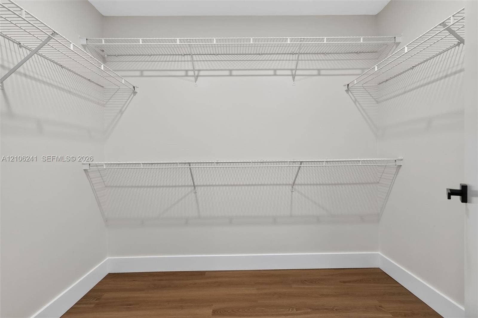 9407 SW 18th Street, Miramar, FL 33025 Walk-in closet featuring tiered wire shelving and wood-finish flooring