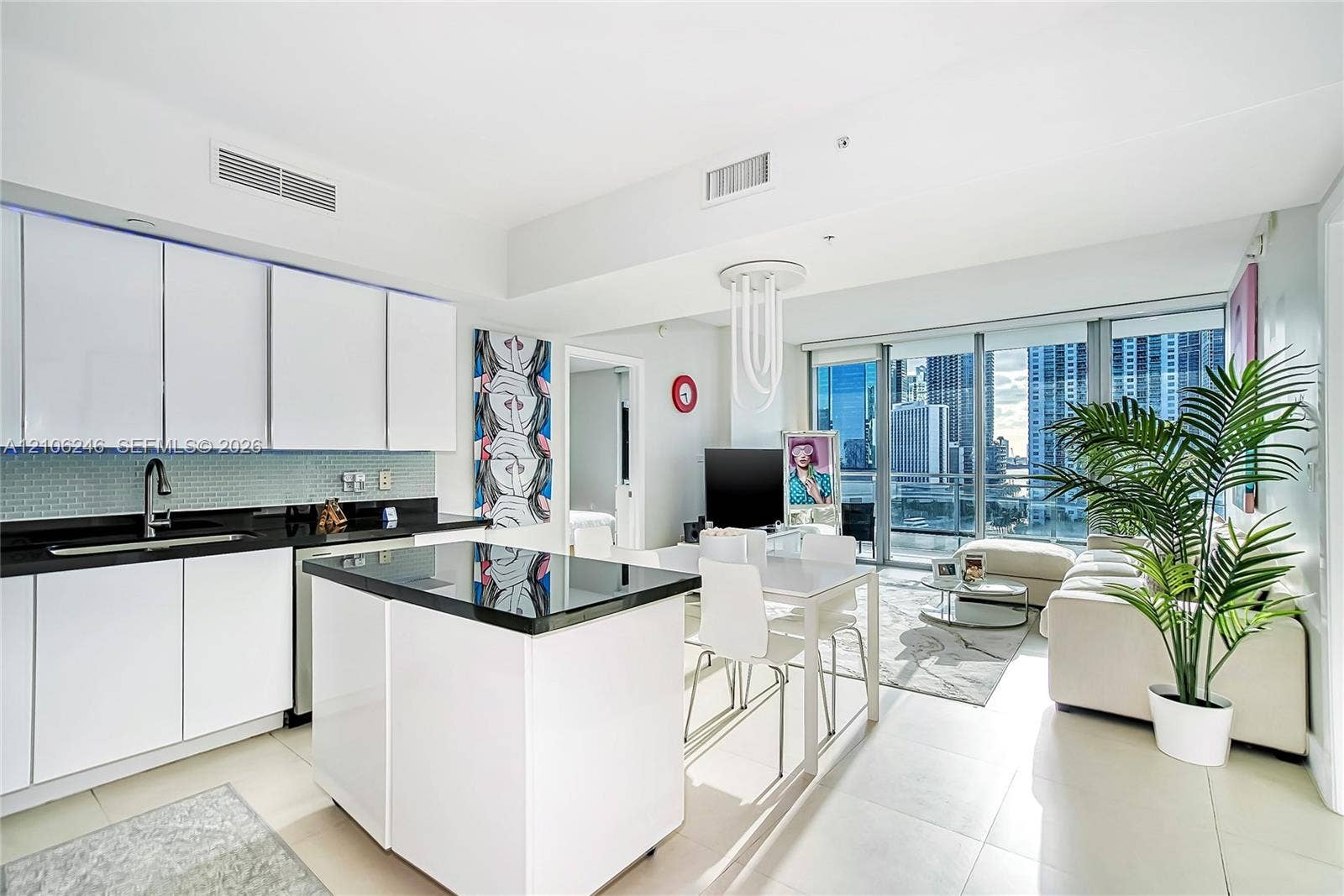 92 SW 3rd Street, #1511, Miami, Miami, FL 33130 Kitchen featuring flat-panel white cabinetry, black stone countertops, tile backsplash, a matching center island, and floor-to-ceiling glass windows