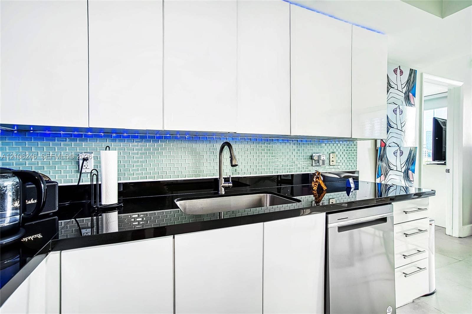 92 SW 3rd Street, #1511, Miami, Miami, FL 33130 Kitchen featuring flat-panel white cabinetry, black stone countertops, an undermount stainless steel sink, a stainless steel dishwasher, and a glass tile backsplash