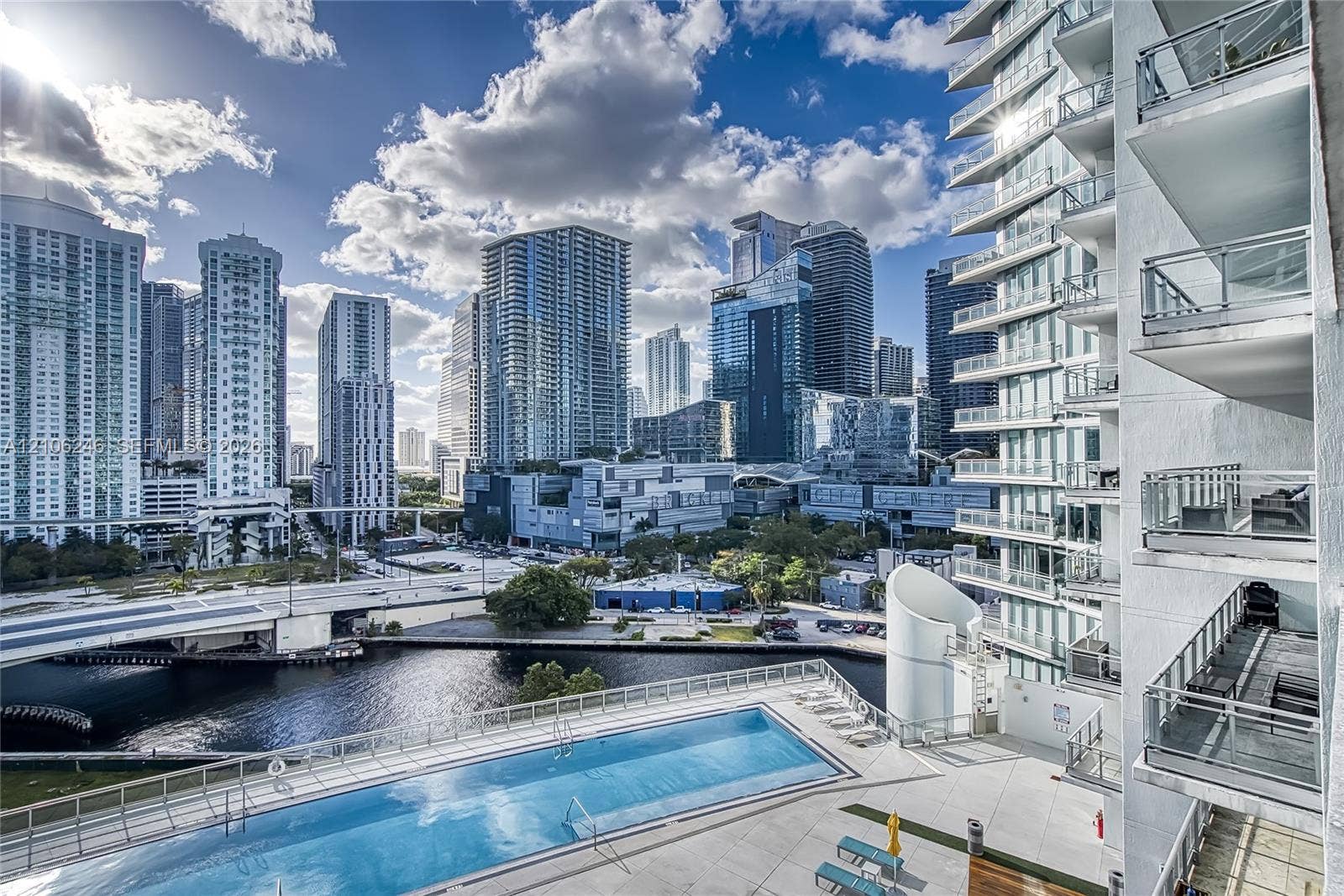 92 SW 3rd Street, #1511, Miami, Miami, FL 33130 Rectangular outdoor swimming pool with a concrete pool deck, multi-level glass-paneled balconies, and architectural skyscraper exterior