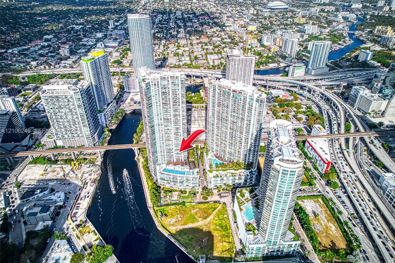 92 SW 3rd Street, #1511, Miami, Miami, FL 33130 High-rise residential tower featuring a glass facade, elevated swimming pools, and waterfront positioning along the river