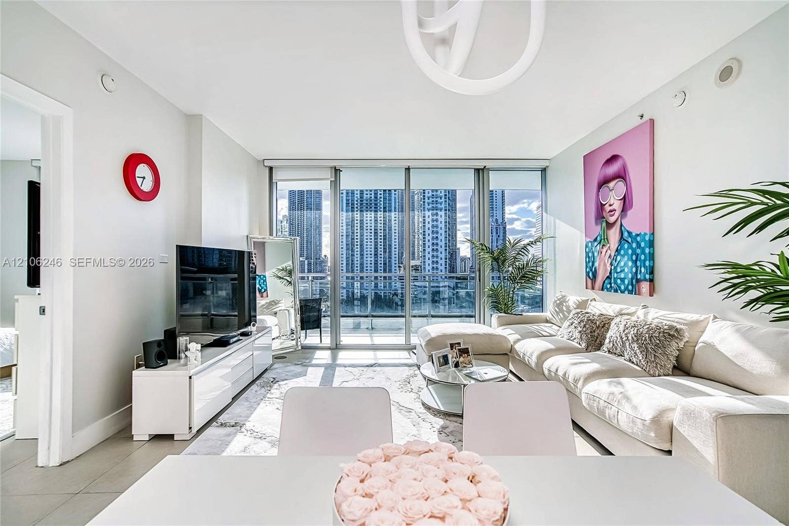 92 SW 3rd Street, #1511, Miami, Miami, FL 33130 Living area featuring floor-to-ceiling windows, porcelain tile flooring, and urban skyscraper scenery