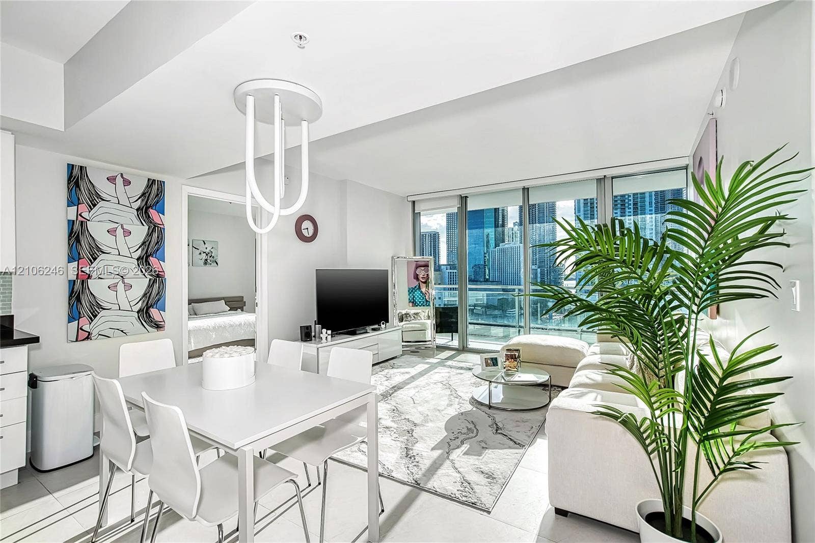 92 SW 3rd Street, #1511, Miami, Miami, FL 33130 Open-concept living space featuring floor-to-ceiling windows, porcelain tile flooring, and custom modern pendant lighting