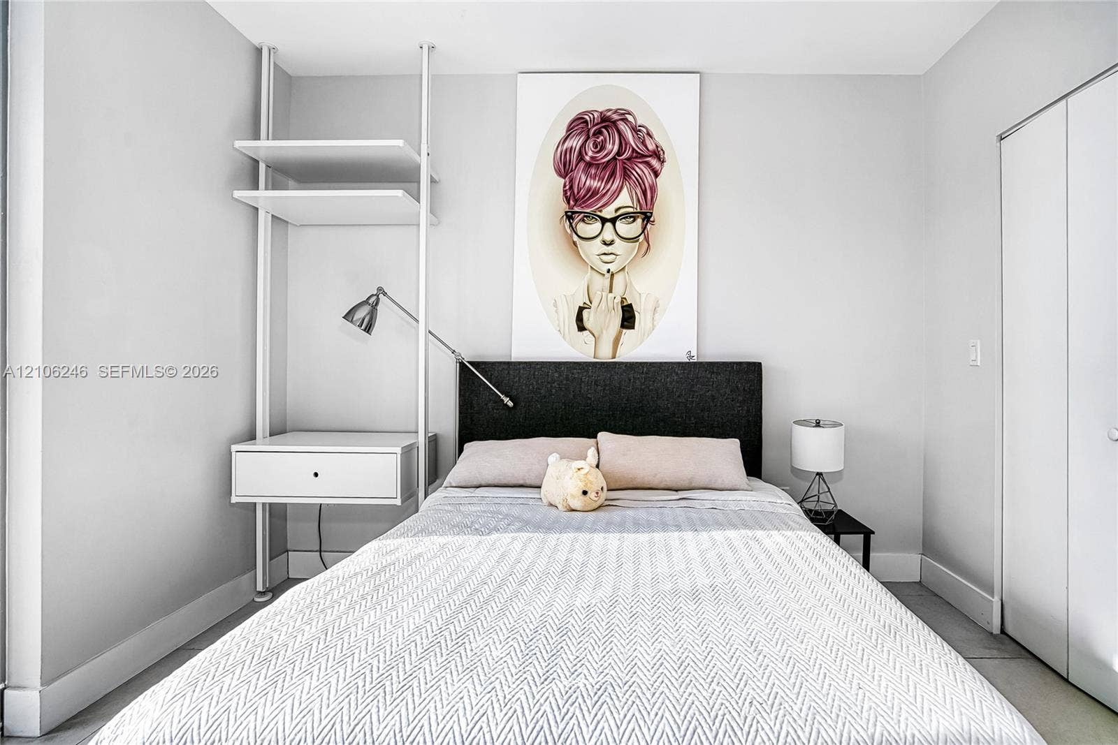 92 SW 3rd Street, #1511, Miami, Miami, FL 33130 Built-in white shelving system featuring an integrated floating storage drawer and wall-mounted task lighting, complemented by a floor-to-ceiling closet with dual panel doors