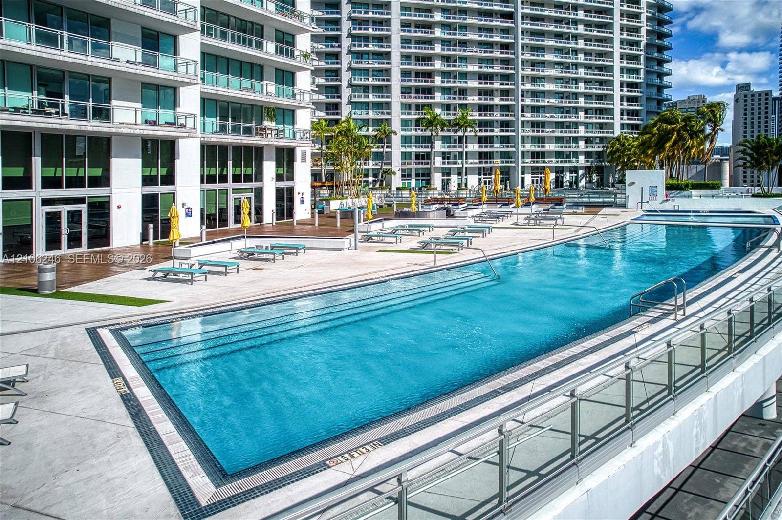 92 SW 3rd Street, #1511, Miami, Miami, FL 33130 Expansive swimming pool with integrated stair entry, surrounded by a paved sun deck and wood-finish decking