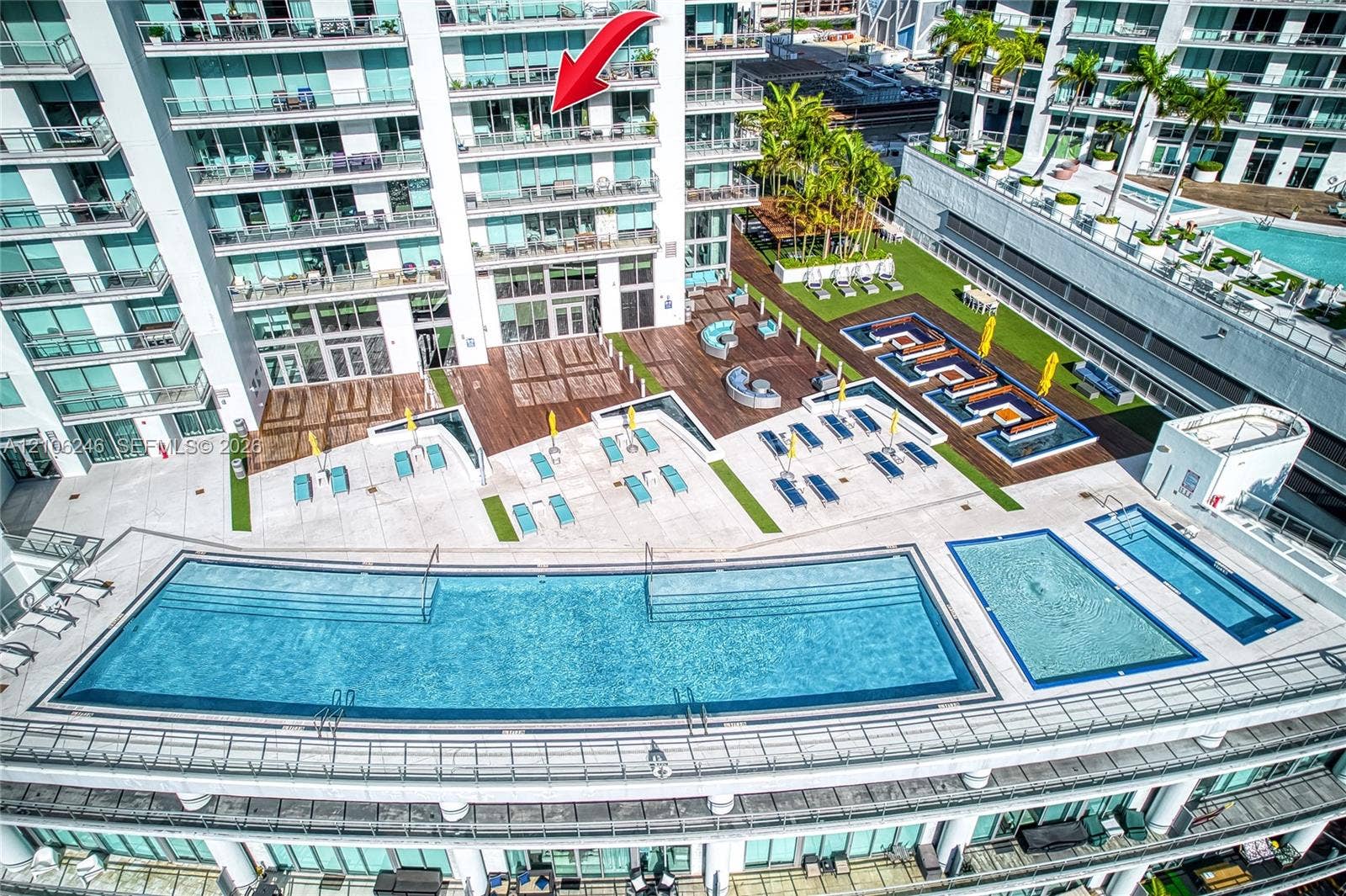 92 SW 3rd Street, #1511, Miami, Miami, FL 33130 Elevated terrace balcony featuring floor-to-ceiling glass panel doors, exterior swimming pool, multi-level sundeck, and landscaped grounds
