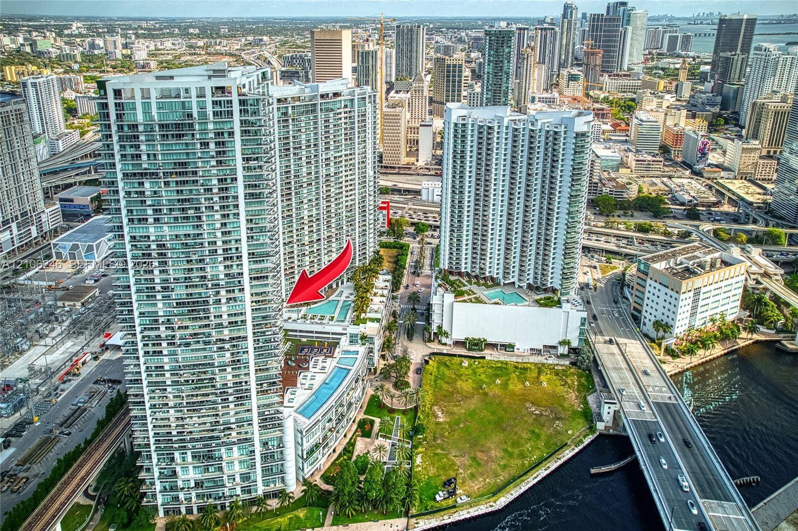 92 SW 3rd Street, #1511, Miami, Miami, FL 33130 High-rise residential tower featuring a multi-level swimming pool deck, glass balcony railings, floor-to-ceiling windows, and direct urban skyline exposure
