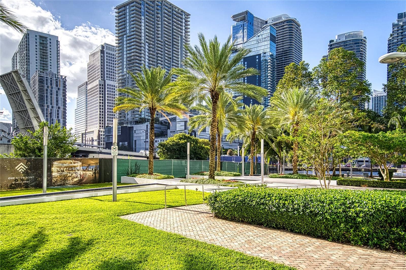 92 SW 3rd Street, #1511, Miami, Miami, FL 33130 Landscaped outdoor grounds featuring a manicured lawn, palm trees, clipped hedges, and brick paver walkways