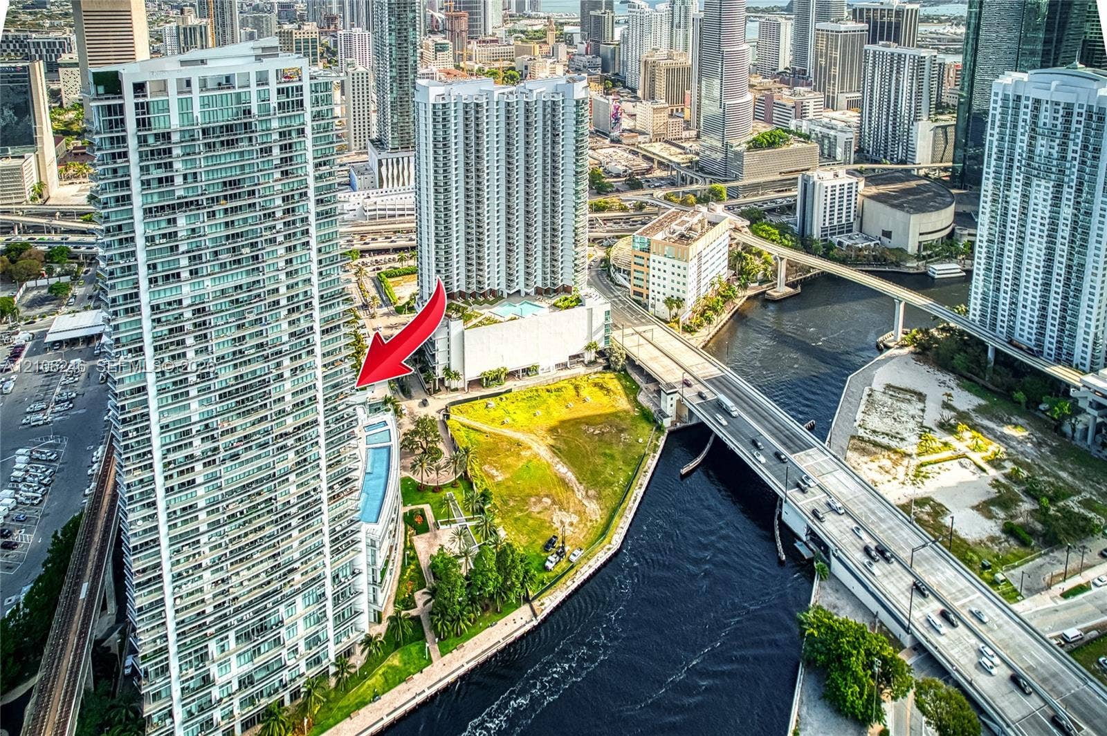 92 SW 3rd Street, #1511, Miami, Miami, FL 33130 High-rise residential tower featuring glass-paneled exterior balconies and a multi-level podium structure