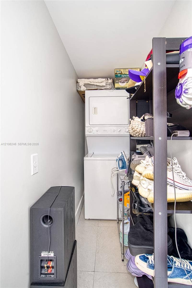92 SW 3rd Street, #1511, Miami, Miami, FL 33130 Dedicated laundry area featuring a stacked washer and dryer unit and neutral floor tiling