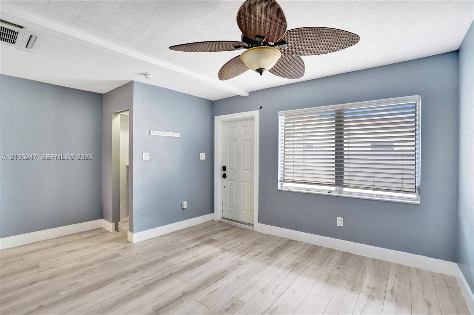 1037 N Victoria Park Road, #2, Fort Lauderdale, Fort Lauderdale, FL 33304 Wood-finish flooring, ceiling fan with integrated light fixture, window with horizontal blinds, and neutral wall color