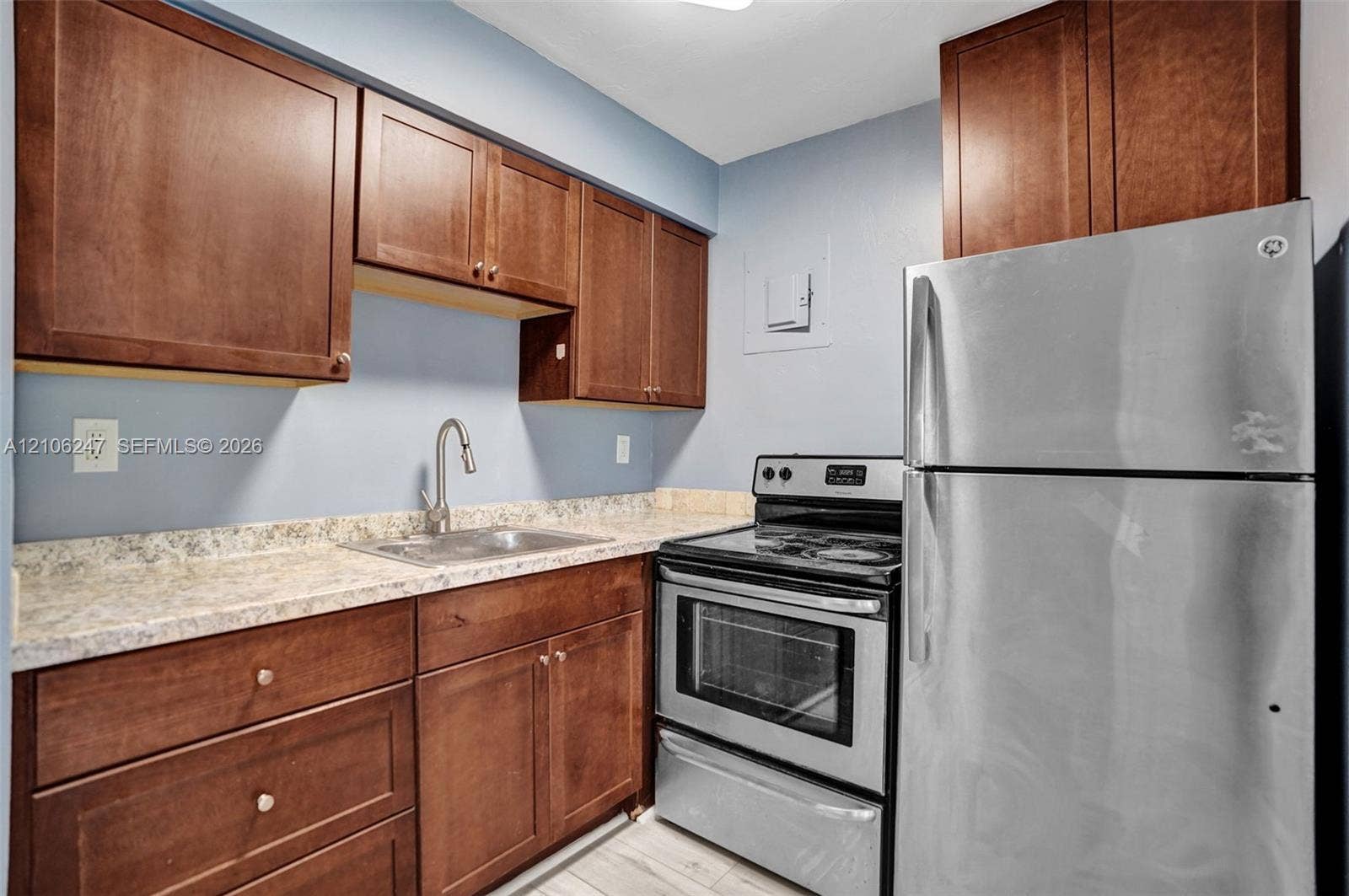 1037 N Victoria Park Road, #2, Fort Lauderdale, Fort Lauderdale, FL 33304 Kitchen featuring wood cabinetry, stone-finish countertops, stainless steel appliances, and a gooseneck faucet