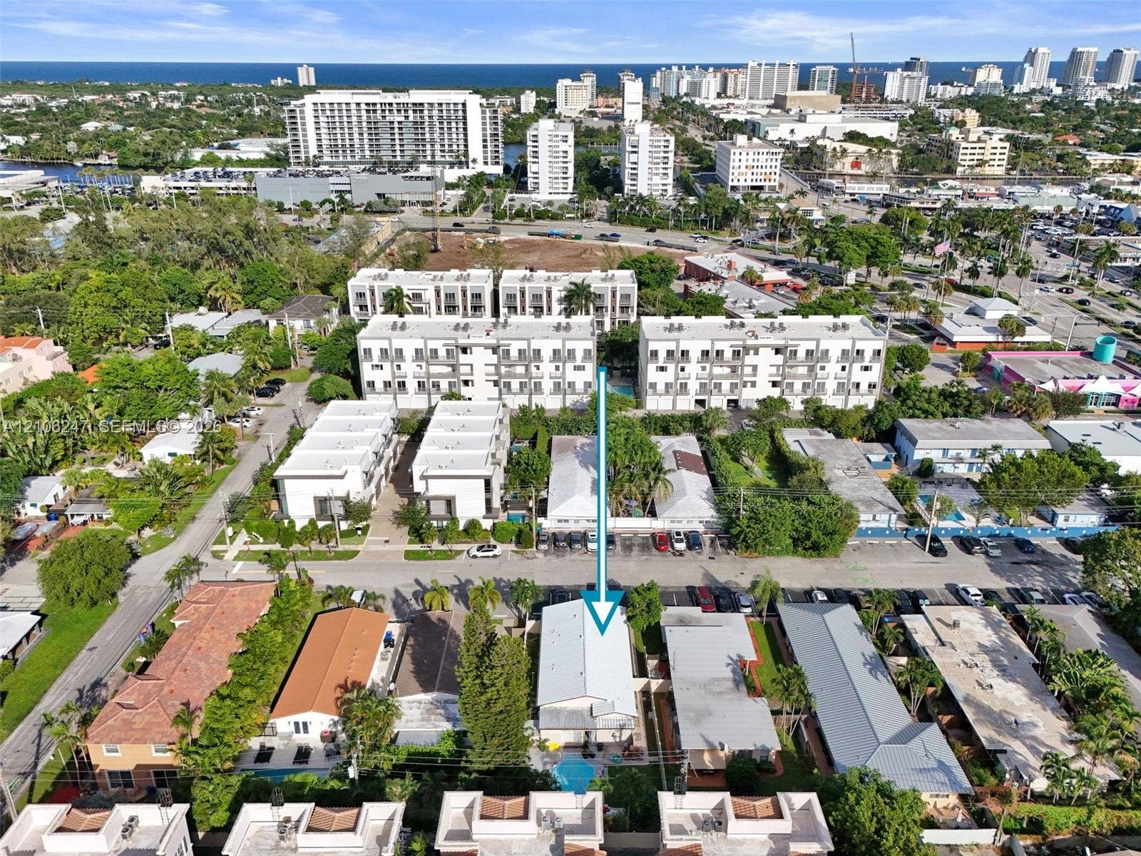 1037 N Victoria Park Road, #2, Fort Lauderdale, Fort Lauderdale, FL 33304 Aerial perspective featuring a low-rise residential structure with a light-colored roof, private swimming pool, and dedicated surface parking