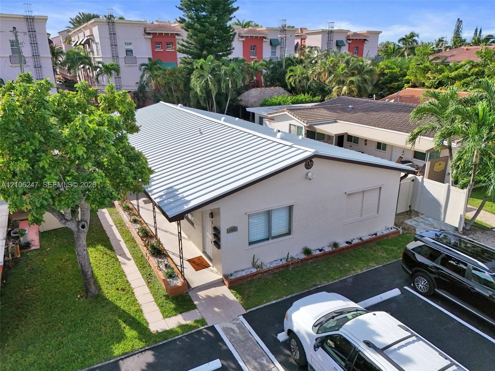1037 N Victoria Park Road, #2, Fort Lauderdale, Fort Lauderdale, FL 33304 Single-story residence featuring a standing-seam metal roof, stucco exterior, covered front porch, and dedicated paved parking area