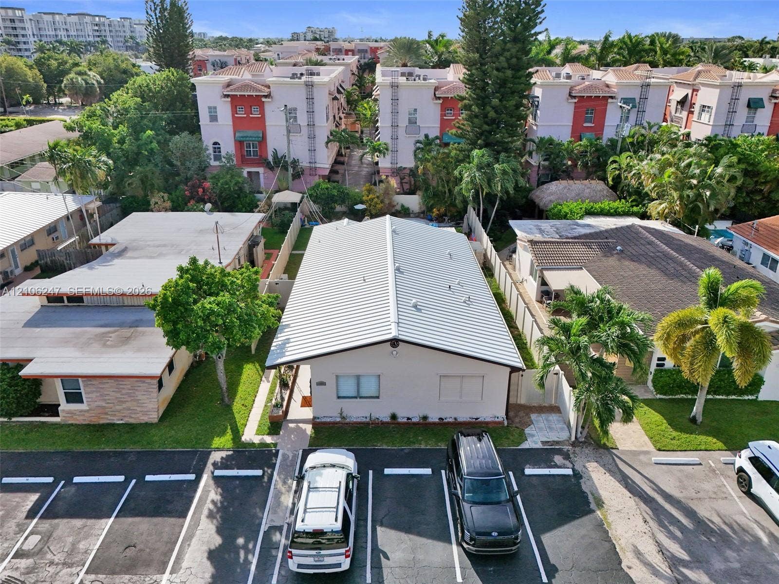 1037 N Victoria Park Road, #2, Fort Lauderdale, Fort Lauderdale, FL 33304 Exterior featuring a metal roof, light-toned siding, and dedicated surface parking