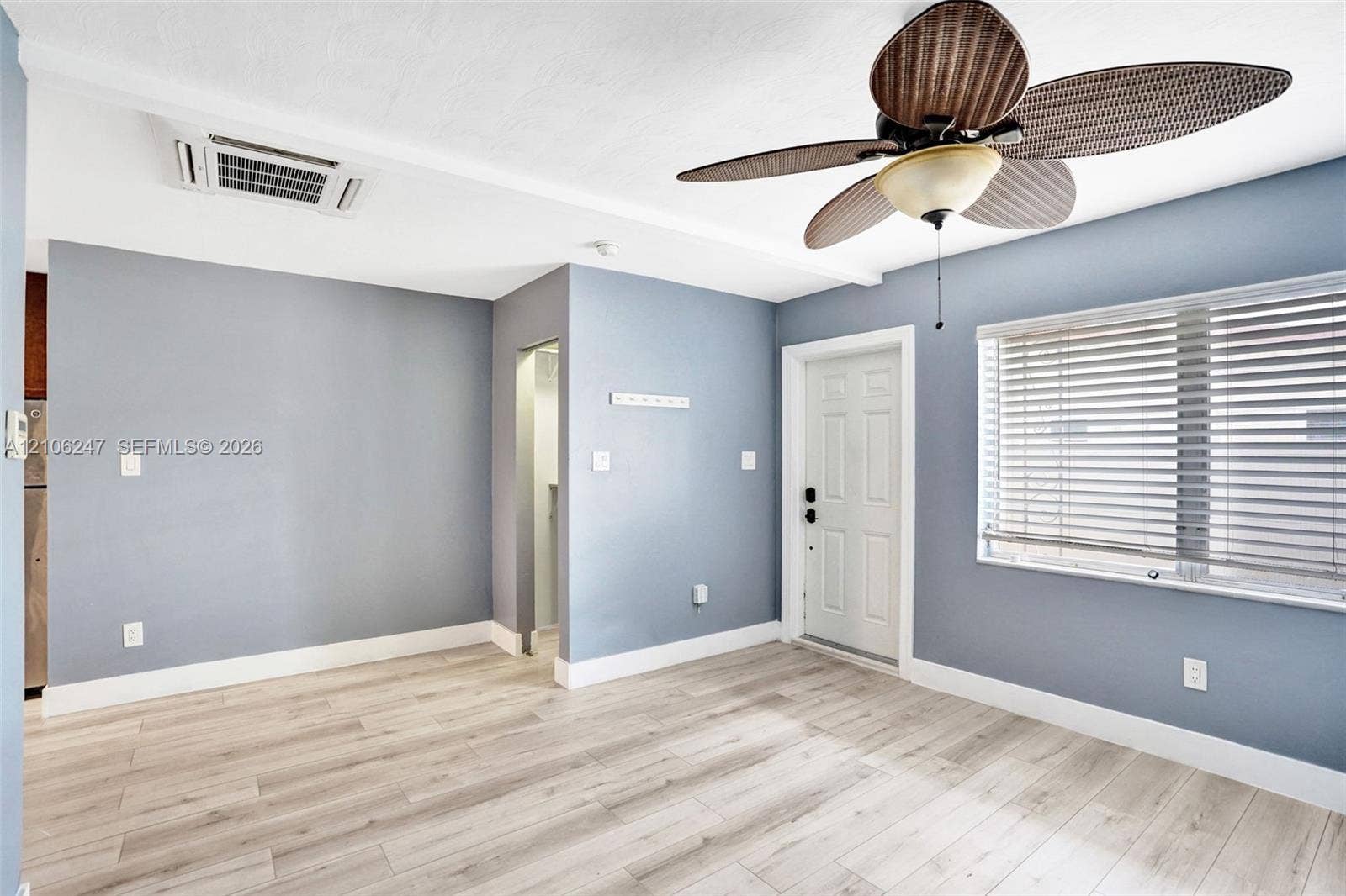 1037 N Victoria Park Road, #2, Fort Lauderdale, Fort Lauderdale, FL 33304 Wood-finish flooring, ceiling fan with integrated lighting, multi-panel door, and window with horizontal blinds