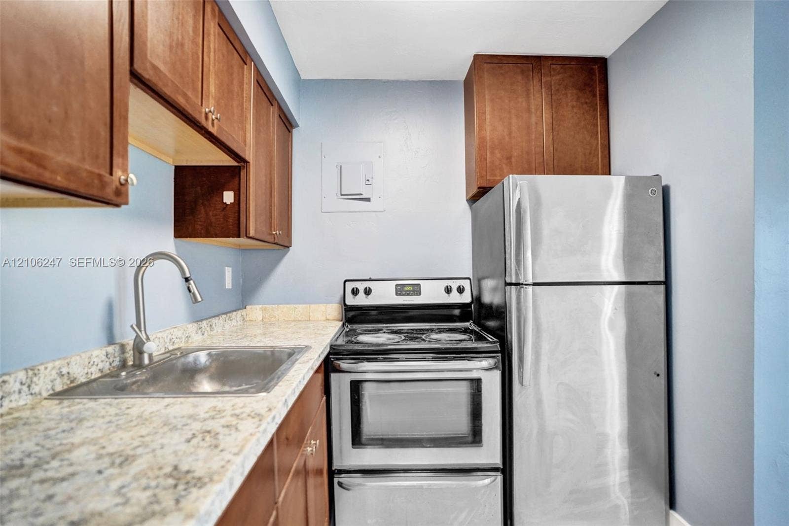 1037 N Victoria Park Road, #2, Fort Lauderdale, Fort Lauderdale, FL 33304 Kitchen featuring wood cabinetry, stone-finish countertops, a stainless steel sink with a high-arch faucet, and stainless steel appliances