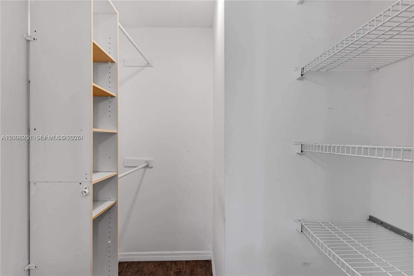 Walk-in closet featuring wood-finish flooring, built-in shelving unit, and multiple wire shelving tiers
