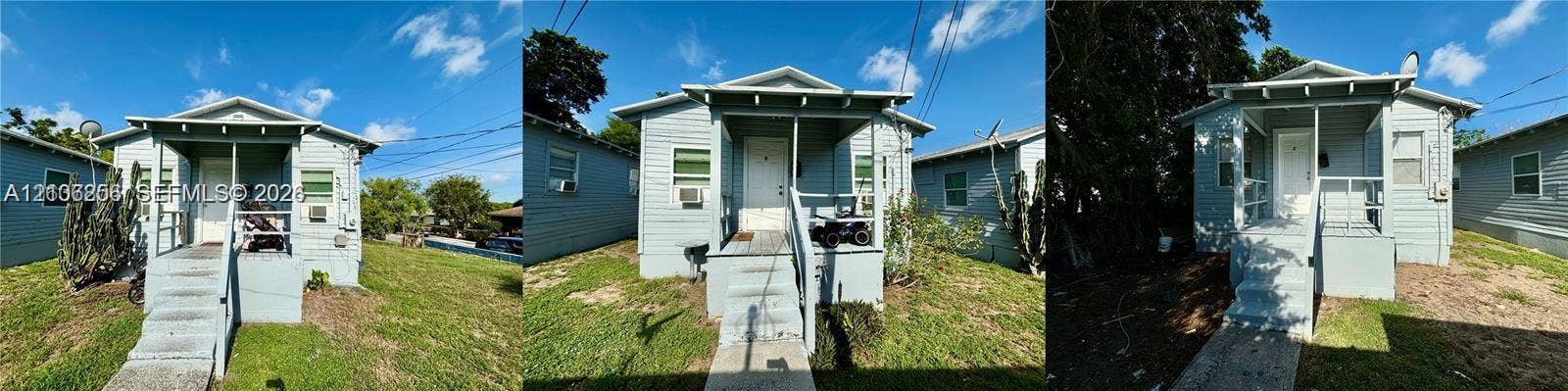 820 21st Street, West Palm Beach, FL 33407 Single-story residence featuring light-colored horizontal siding, a gabled roofline, a raised front porch with metal railings, and concrete stairs