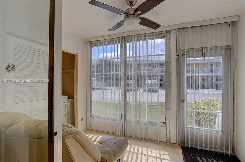 2212 NE 1st Way, #101, Boynton Beach, FL 33435 Floor-to-ceiling windows, glass-panel exterior door, ceiling fan, and tiled flooring