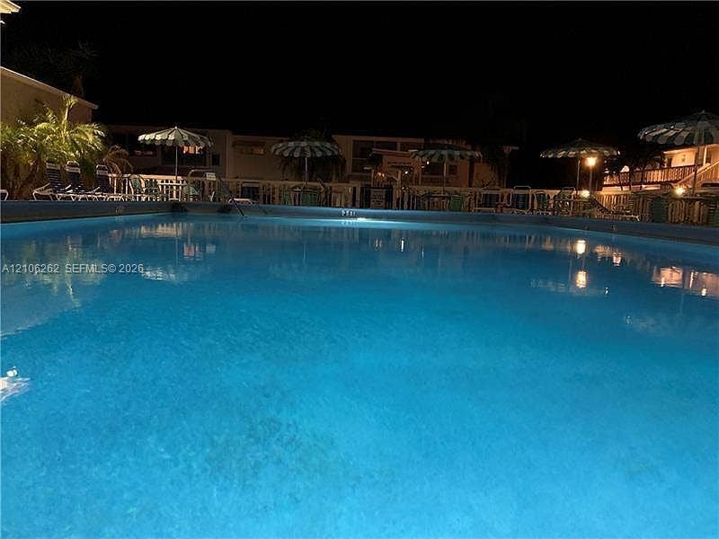 2212 NE 1st Way, #101, Boynton Beach, FL 33435 In-ground swimming pool featuring a concrete perimeter and integrated lighting