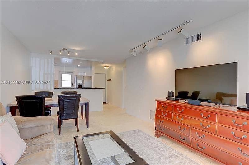 2212 NE 1st Way, #101, Boynton Beach, FL 33435 Open-concept area featuring recessed track lighting, neutral flooring, and a breakfast bar