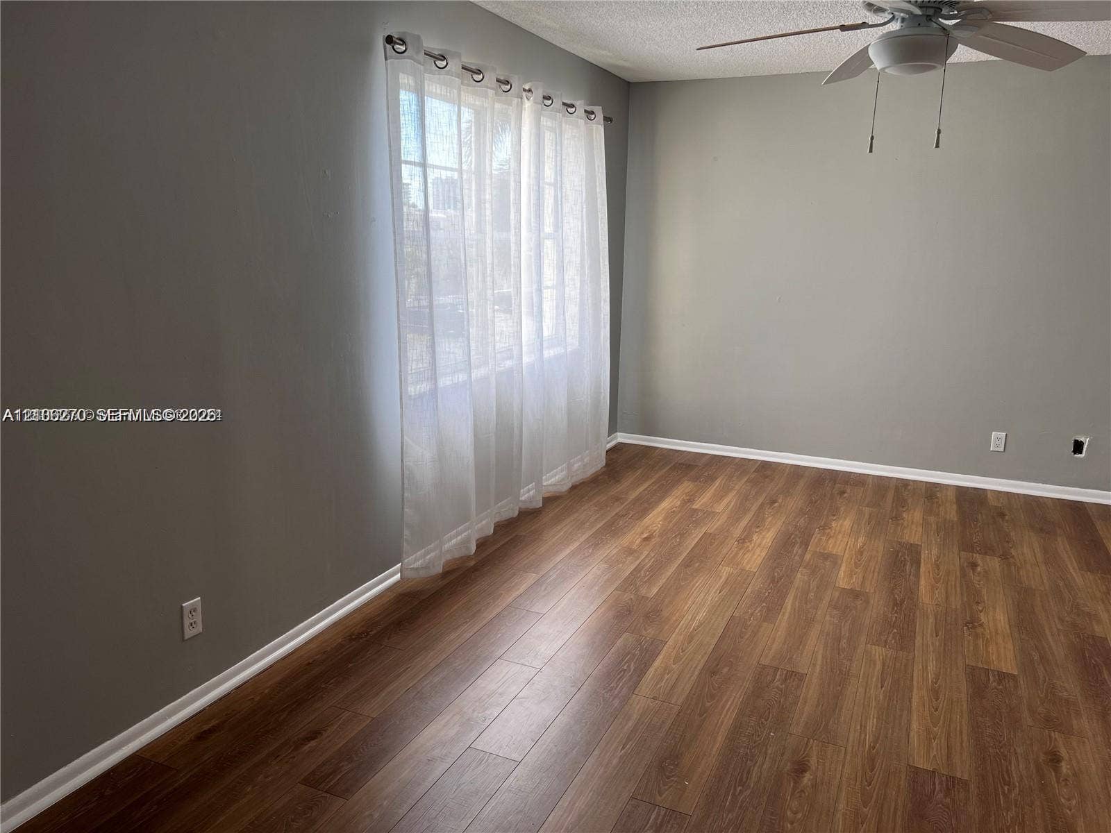 2410 NE 10th Street, #123, Hallandale Beach, Hallandale Beach, FL 33009 Wood-finish flooring, multi-pane window, and ceiling fan