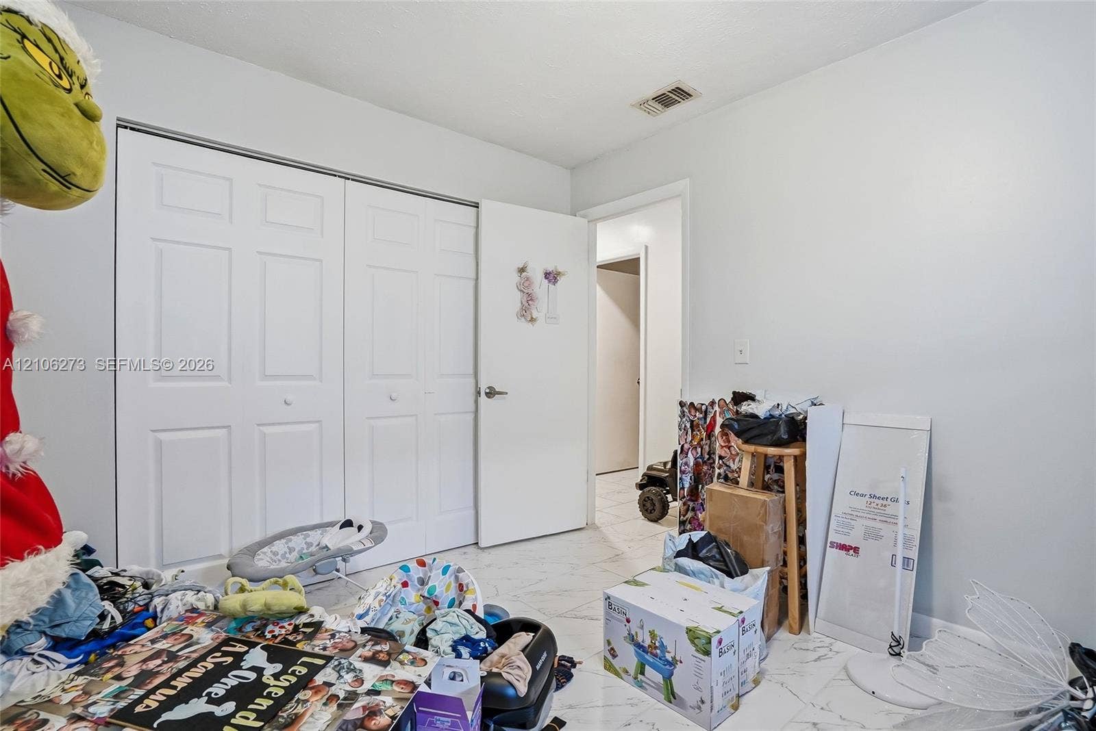 5310 Seagrape Drive, Fort Pierce, FL 34982 Interior space featuring white tile flooring and dual-panel closet doors