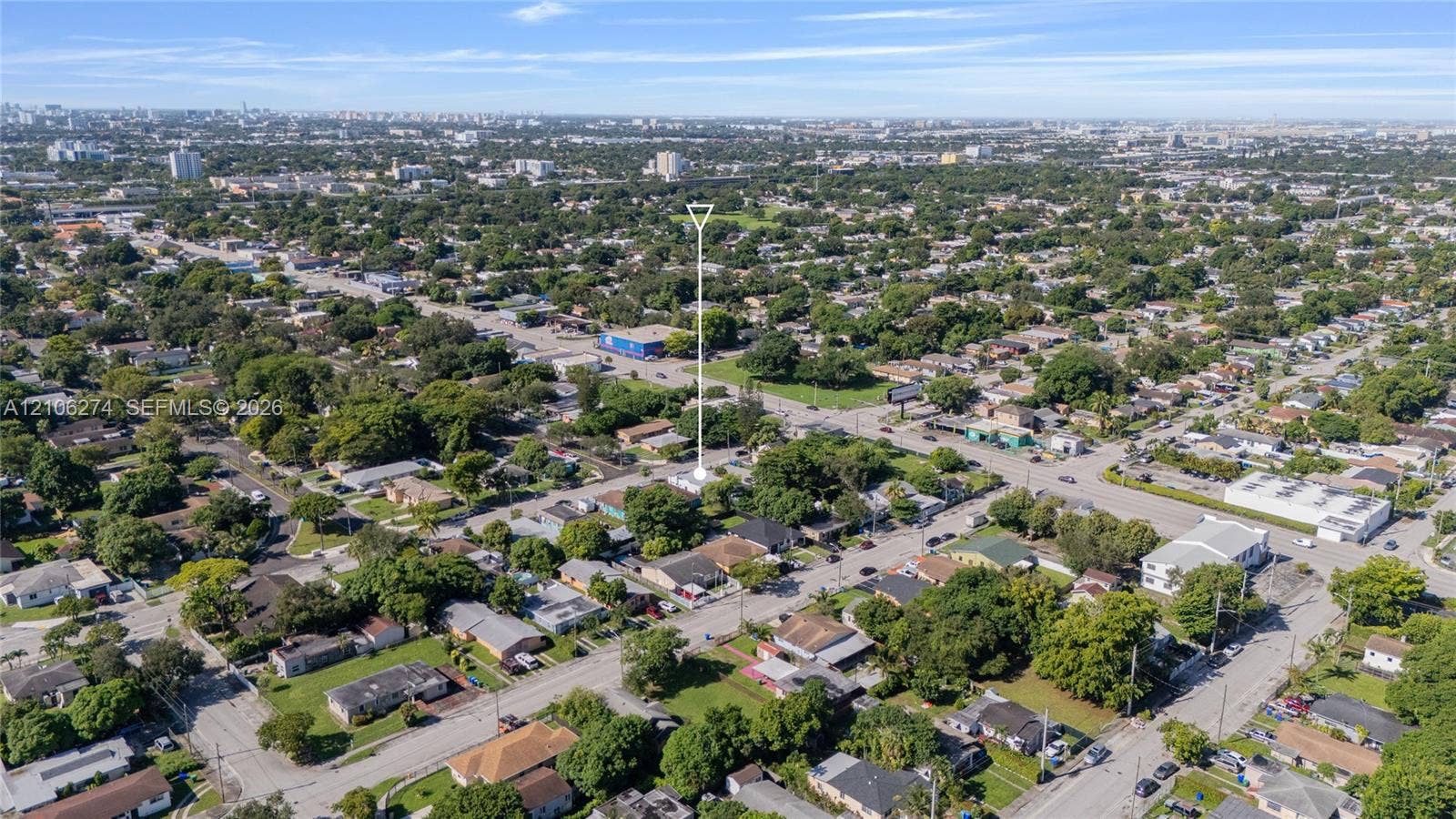 1601 NW 50th Street, Miami, FL 33142 Aerial perspective of a residential lot situated within a suburban grid featuring mature tree canopy and street access