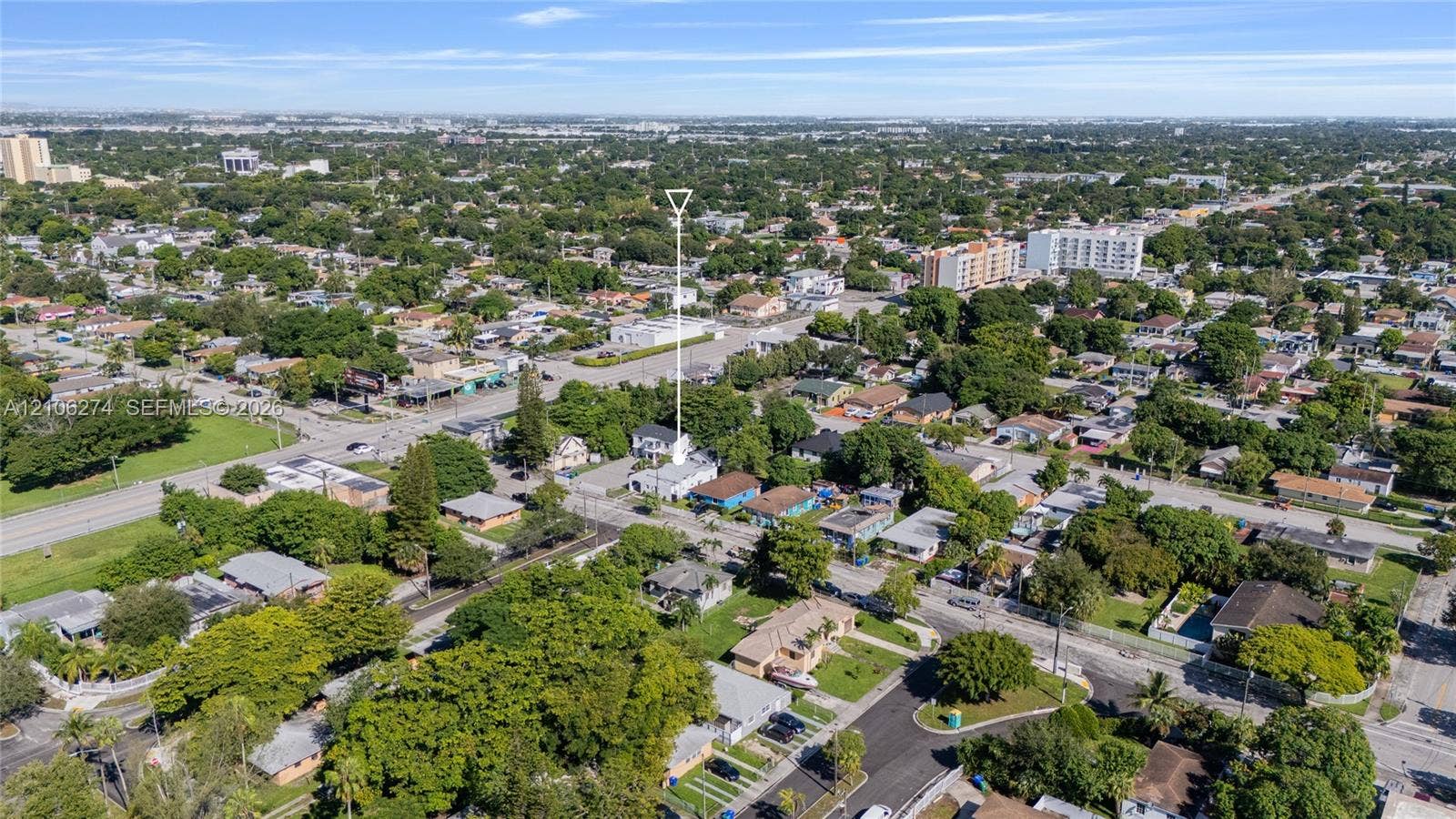 1601 NW 50th Street, Miami, FL 33142 Aerial perspective of residential property featuring a dedicated driveway and mature trees