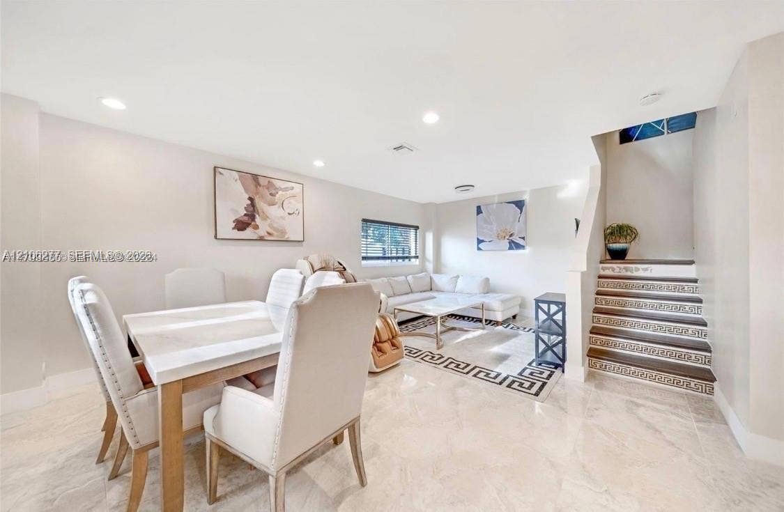 Polished stone flooring, recessed lighting, and a staircase featuring decorative geometric tile risers