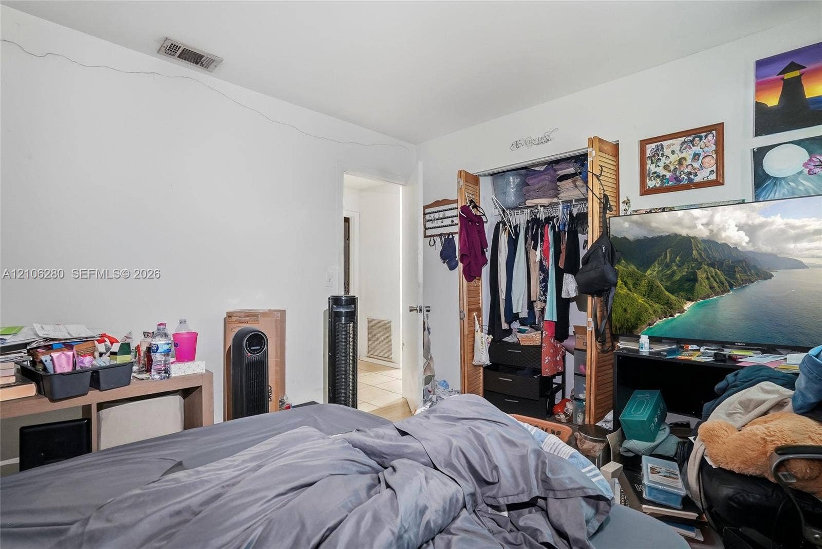 2017 SE Ancora Court, Port St Lucie, FL 34952 Interior space featuring a reach-in closet with bi-fold wooden louvered doors