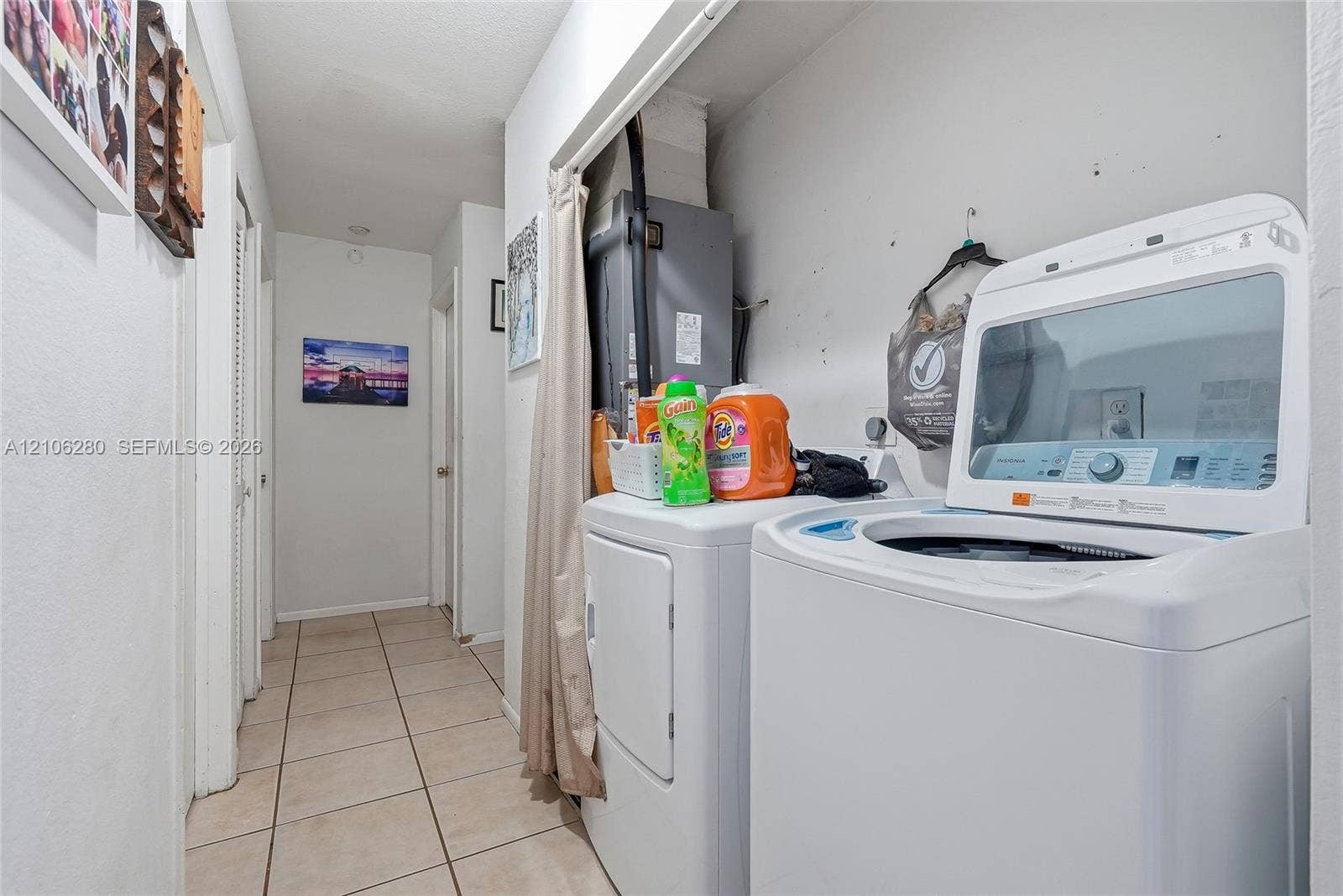 2017 SE Ancora Court, Port St Lucie, FL 34952 Utility area featuring tile flooring and louvered-panel doors