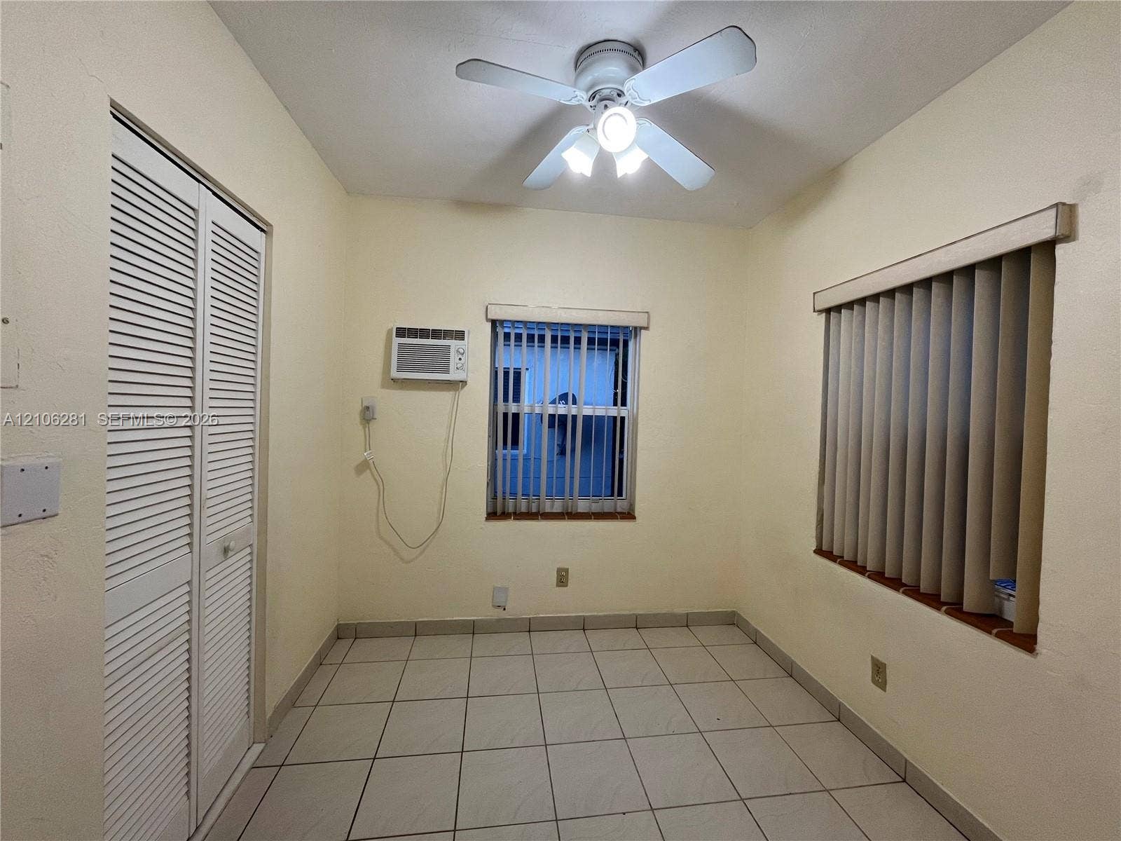 832 SW 31st Avenue, #832, Miami, Miami, FL 33135 Room featuring tile flooring, louvered bi-fold closet doors, a ceiling fan with integrated lighting, and vertical window blinds