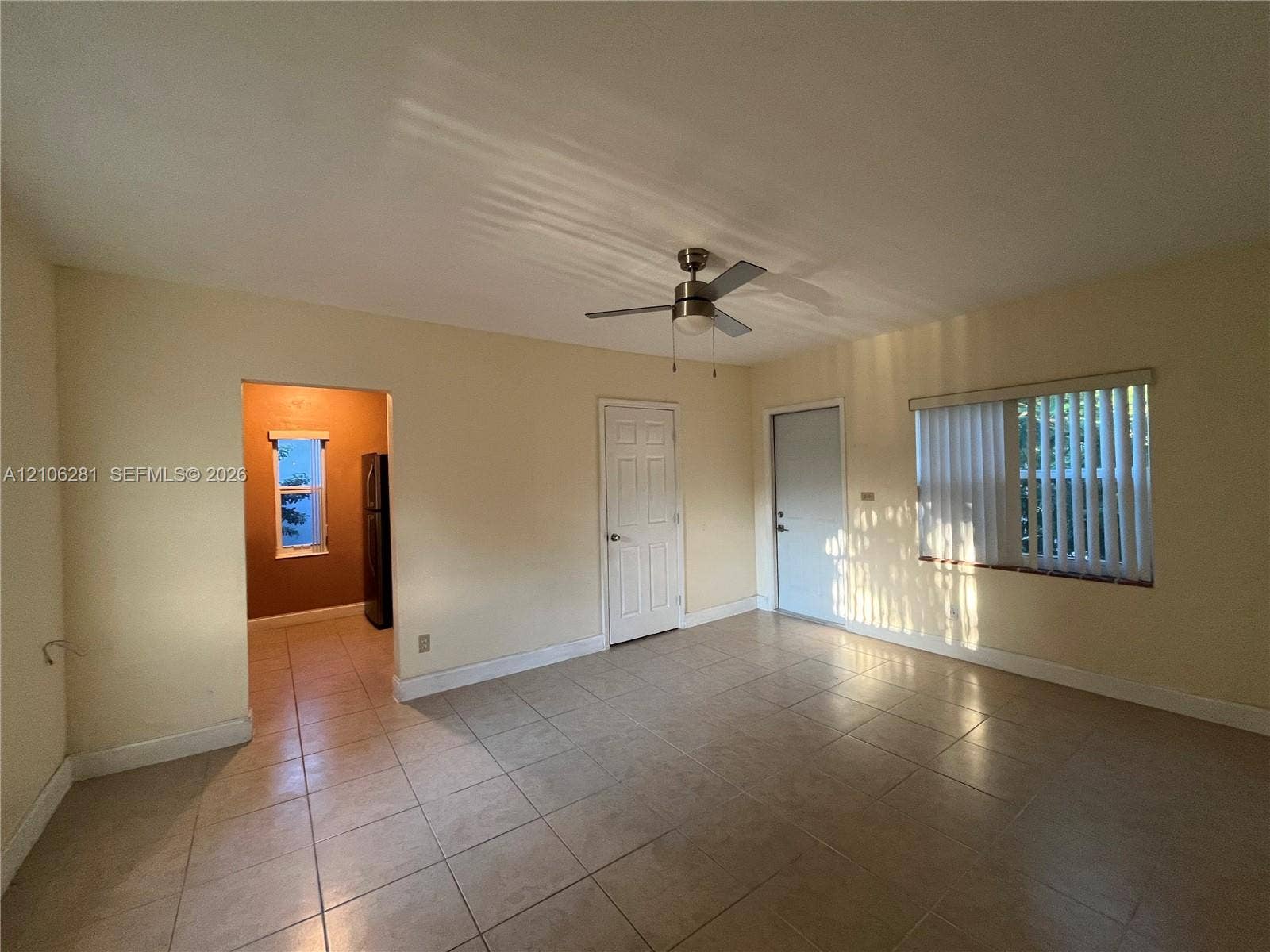 832 SW 31st Avenue, #832, Miami, Miami, FL 33135 Neutral-toned interior featuring ceramic tile flooring, a brushed-nickel ceiling fan, and vertical window blinds