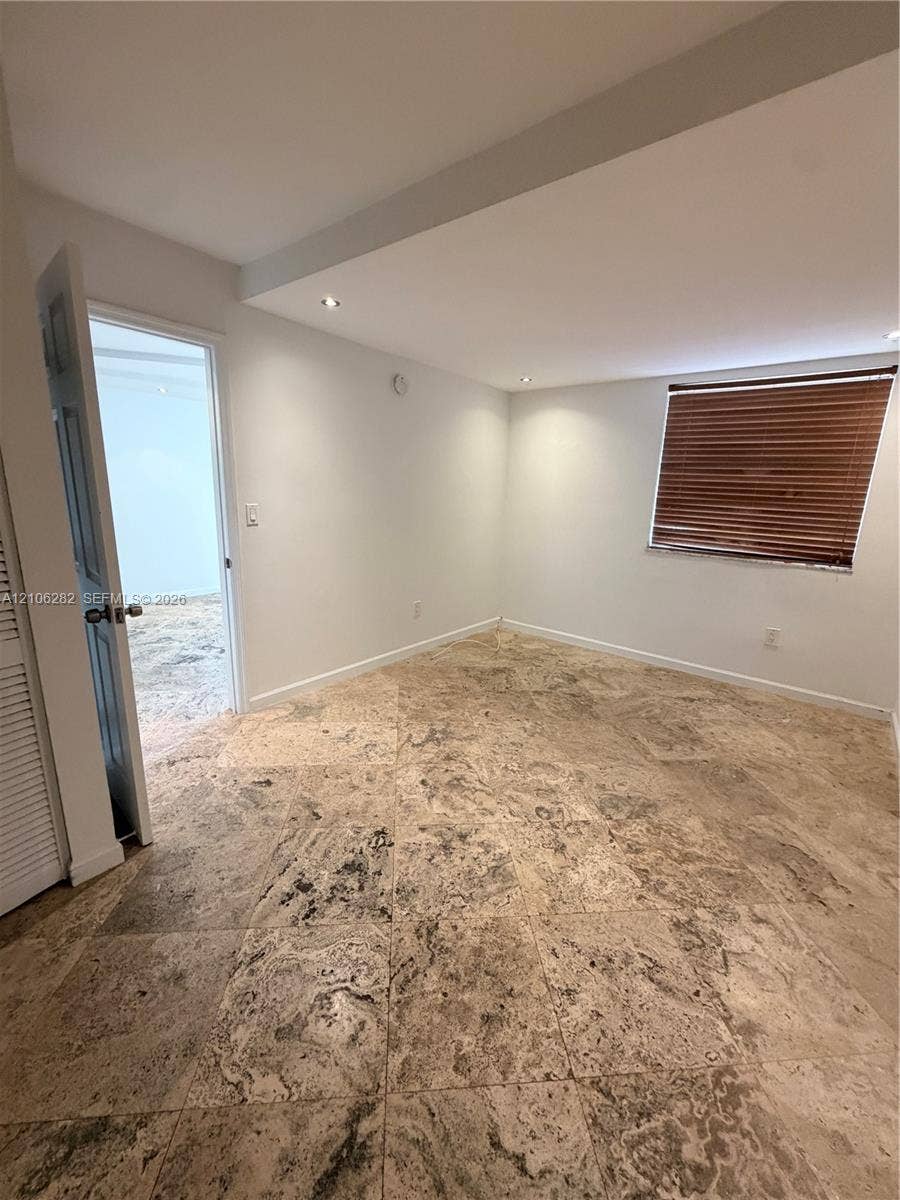 665 NE 83rd Terrace, #210, Miami, Miami, FL 33138 Interior space featuring stone-tile flooring, recessed ceiling lighting, and a louvered closet door